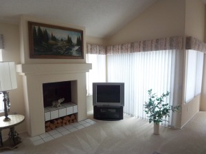 Living room with fireplace and doors to backyard and patio